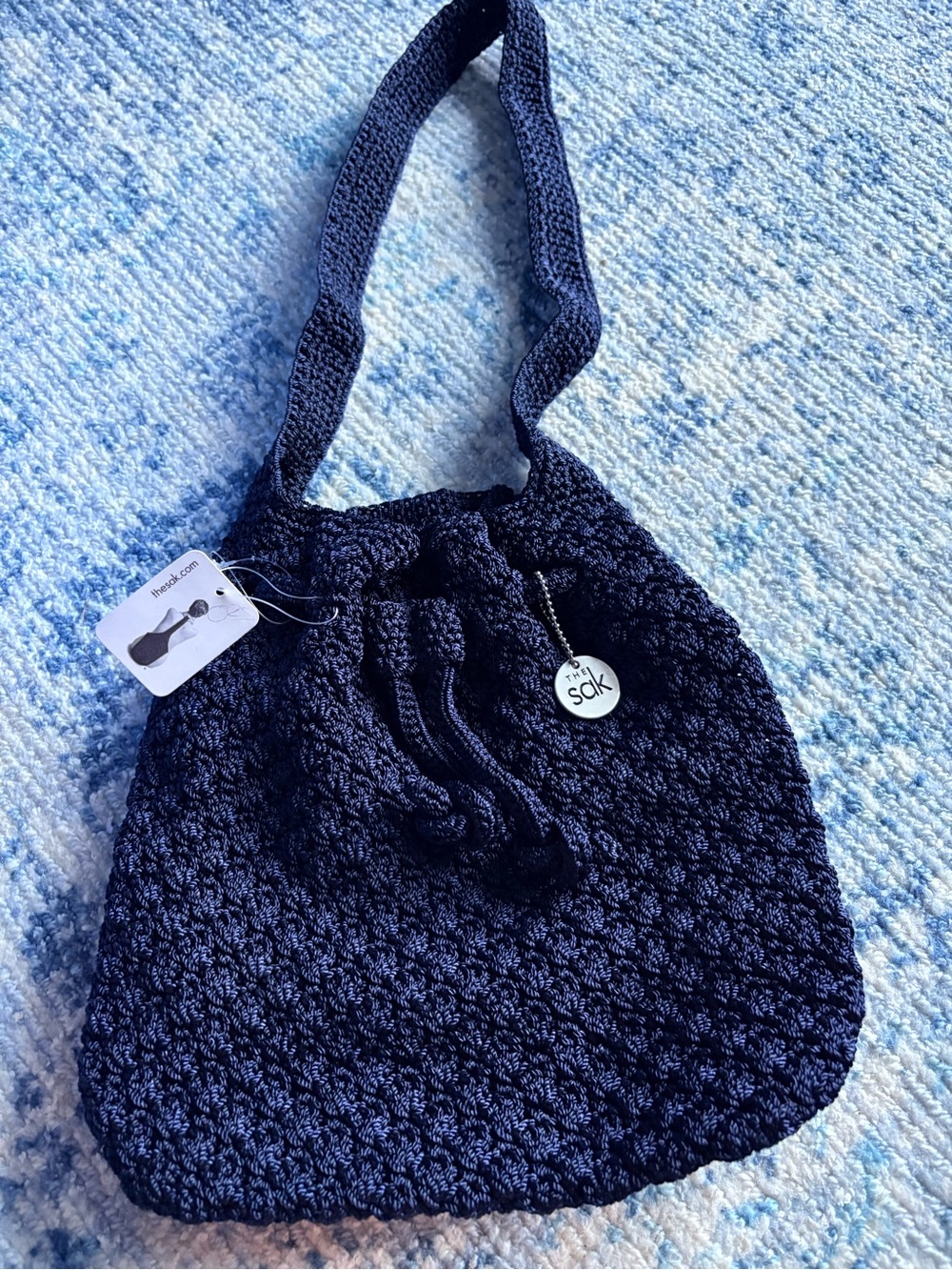 The Sak navy crochet drawstring bucket bag purse